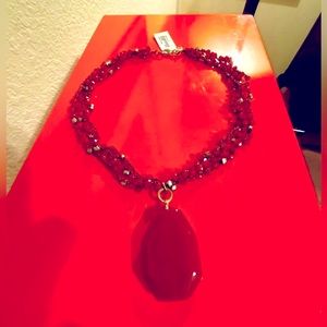 Three stranded beaded red onyx necklace with large red onyx pendant